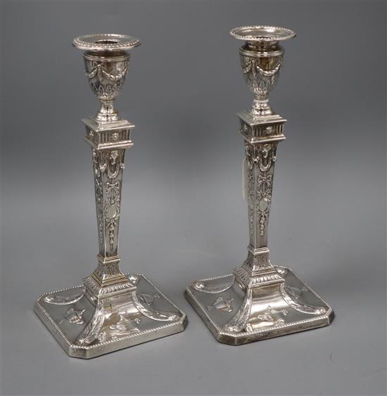 A pair of late Victorian silver Adam style candlesticks by Martin, Hall & Co, London, 1892/4 (one later associated sconce), 29.2cm.